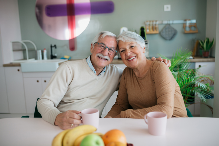 Older retired couple happy they've chosen the right life insurance plan.