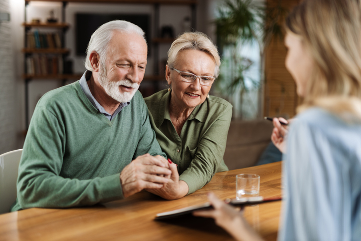 Older couple discussing their underwriting process with their insurance agent